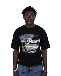 Person wearing a black t-shirt with a graphic design and 'Palm Tree' text on a white background