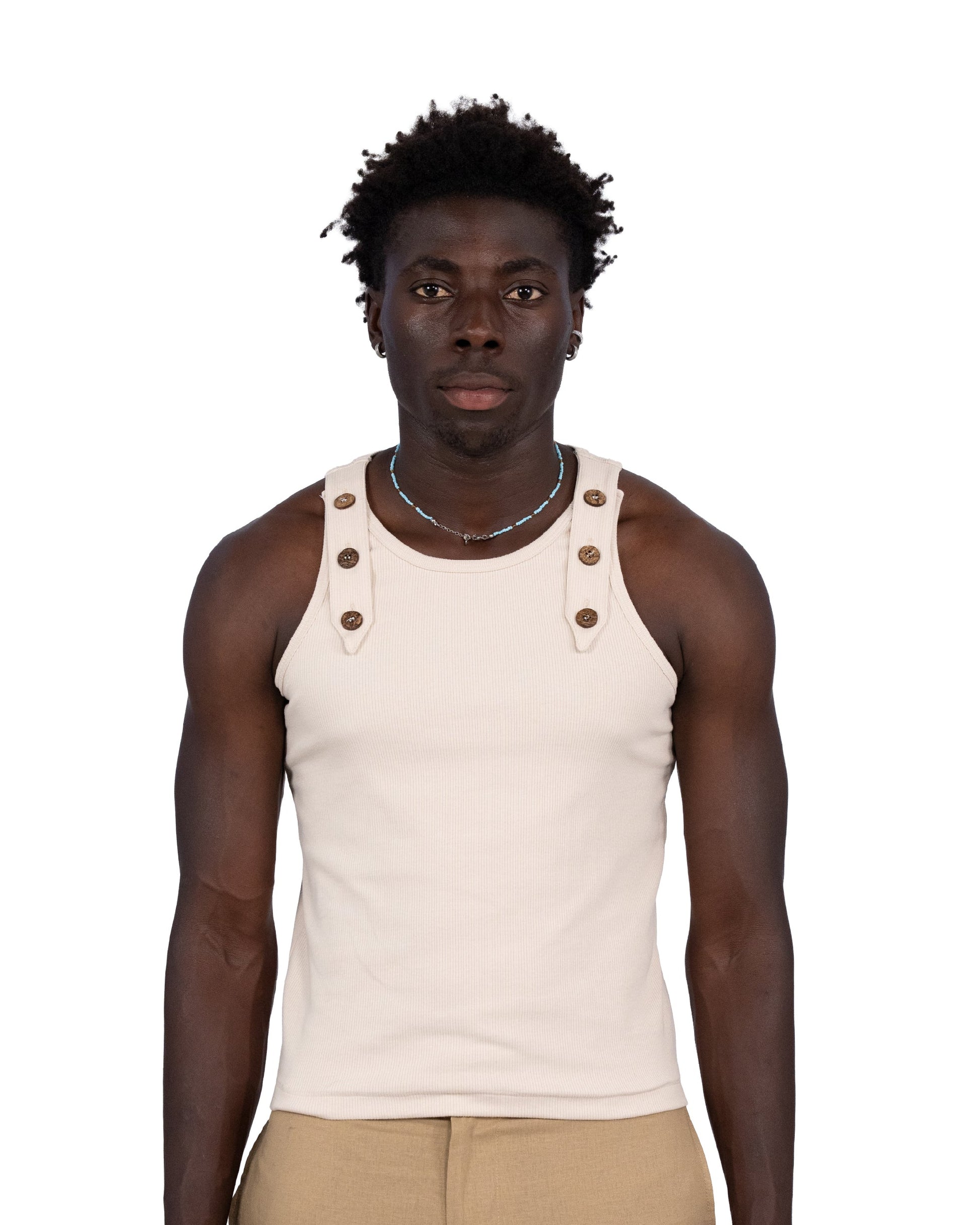 Man wearing a beige tank top with button details on a white background