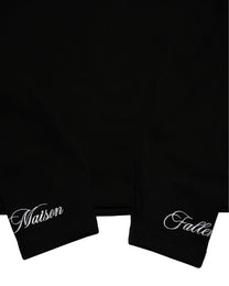 Black garment with 'Naison' and 'Falle' text on a white background