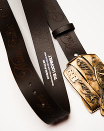 Brown leather belt with gold buckle on a white background