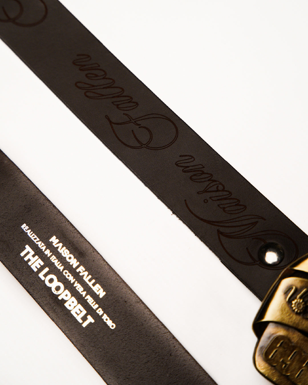 Brown leather belt with gold buckle on a white background