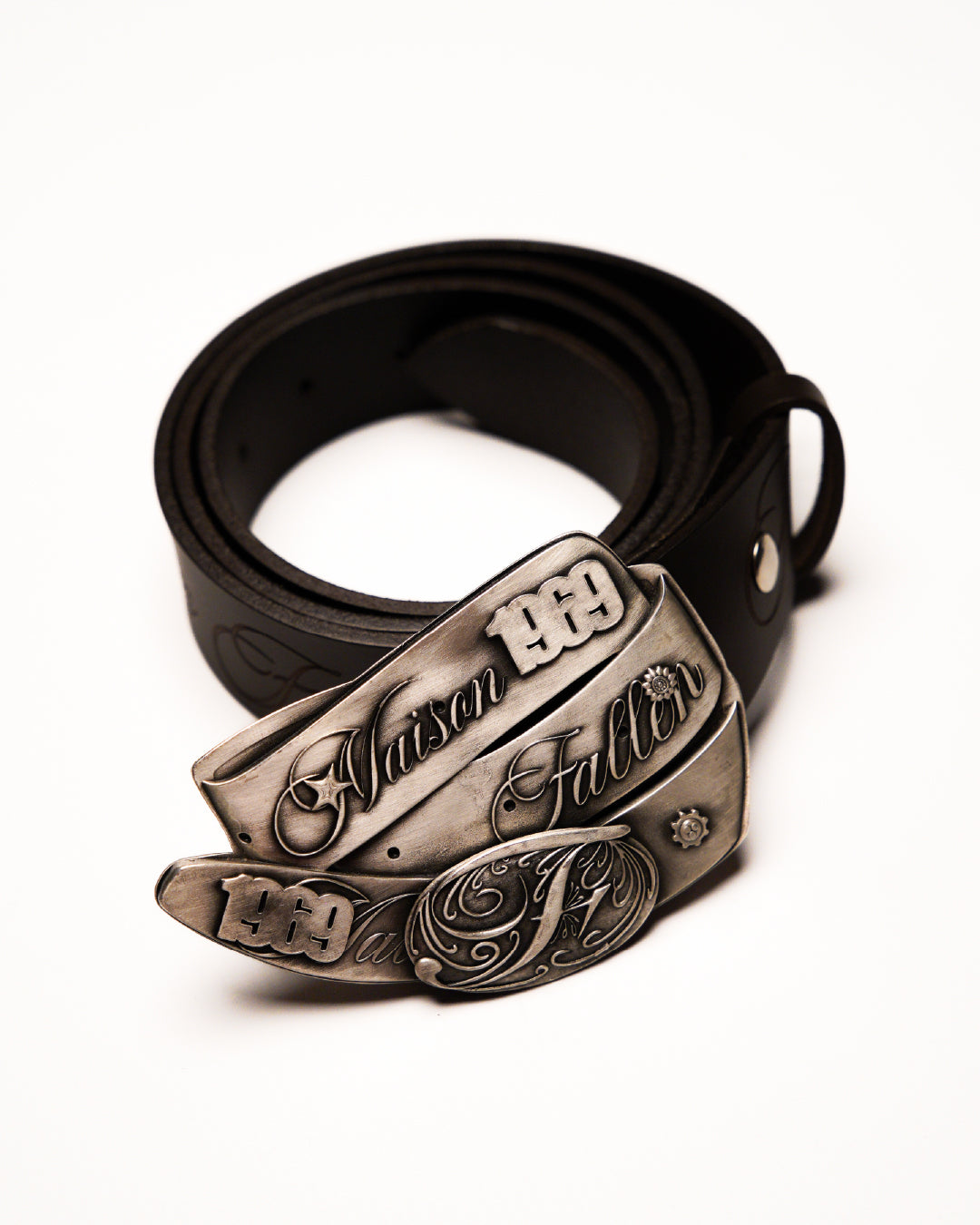 Black leather belt with bronze buckle on a white background