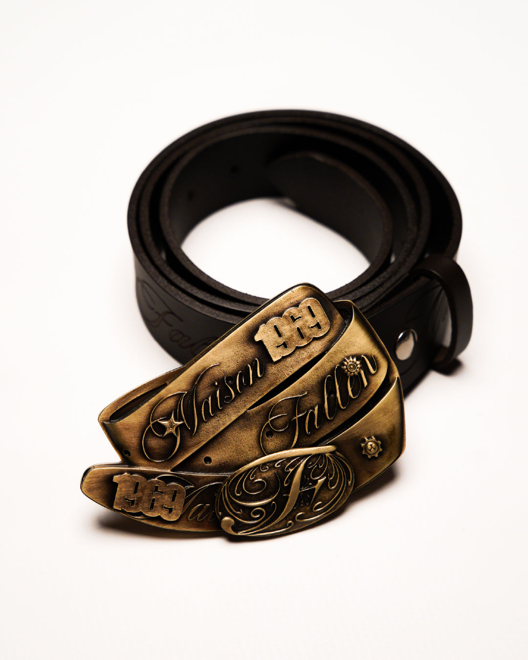 Black belt with a bronze buckle on a white background