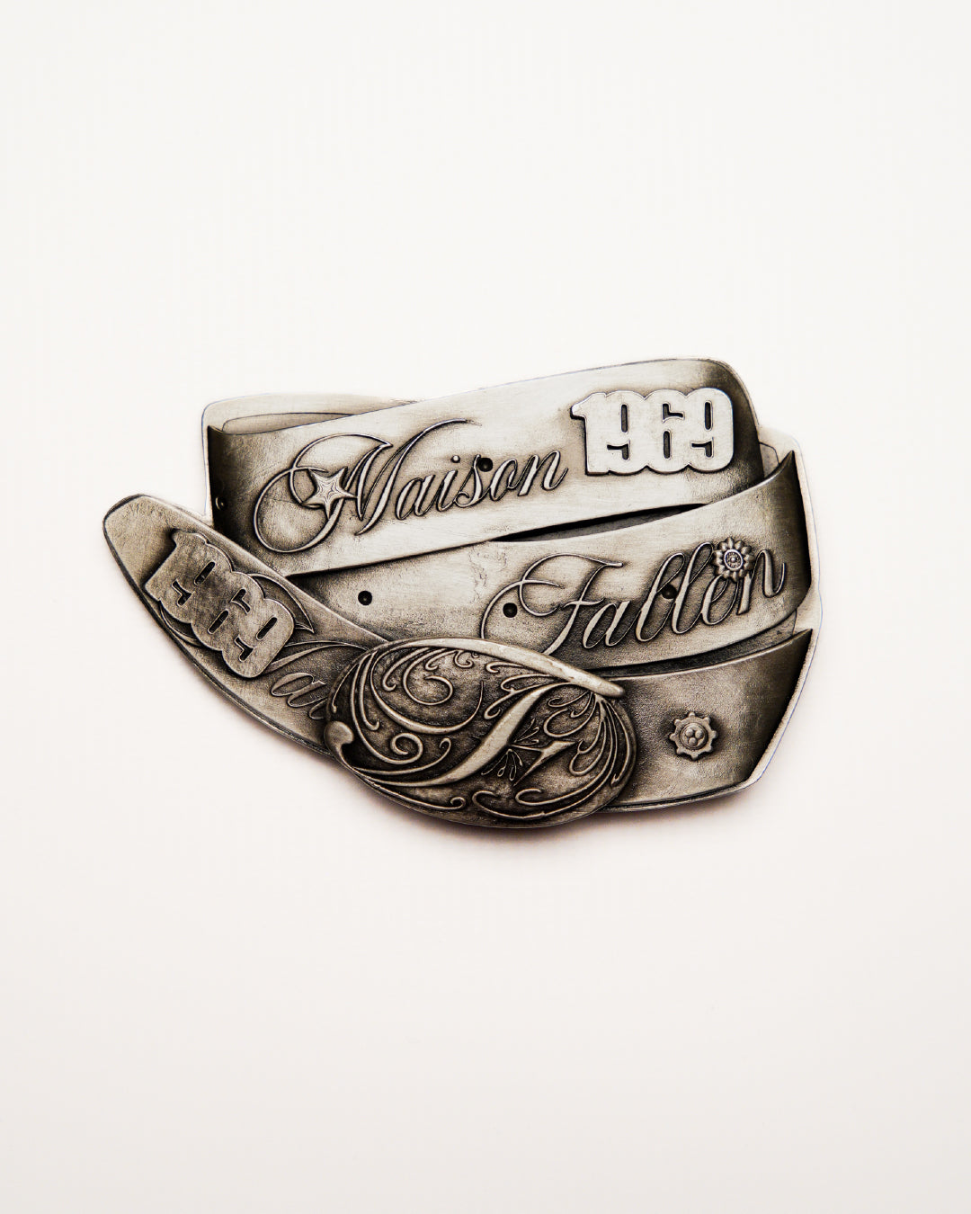 Silver ring with engraved text on a white background