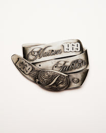 Silver ring with engraved text on a white background