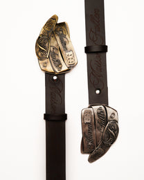 Two leather straps with metal ends featuring intricate designs on a white background.